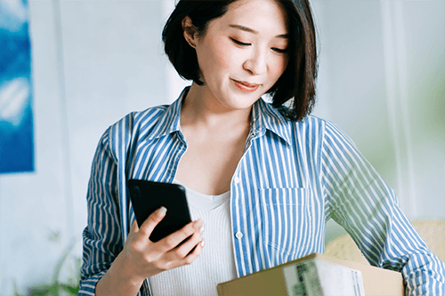 A woman making an online purchase return on her mobile